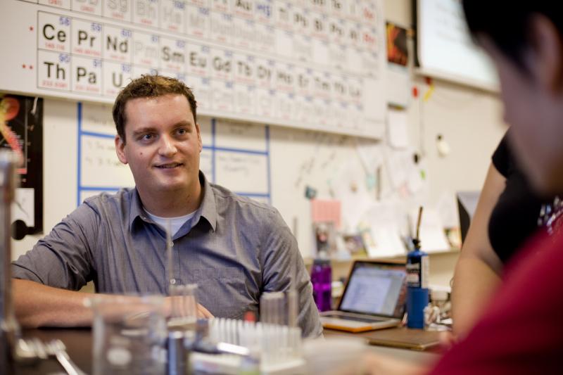 Photo of a teacher listening to a student.