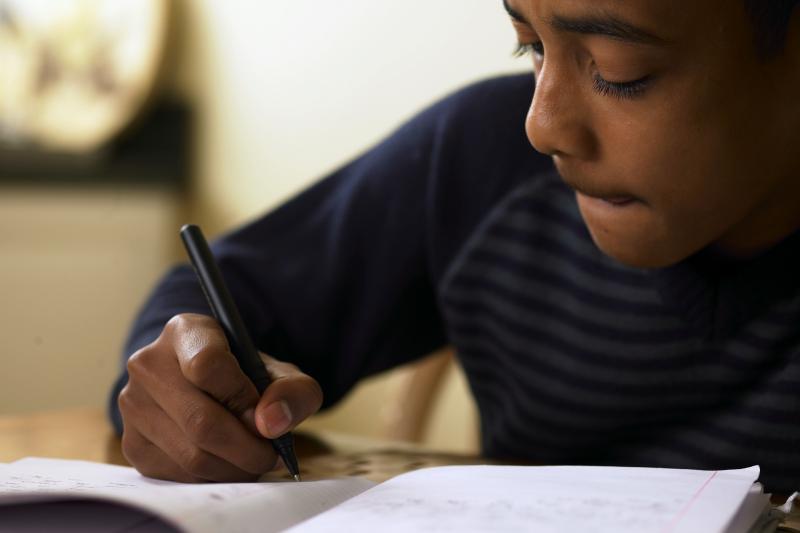 Photo of boy doing schoolwork at home
