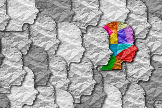 Illustration of a colorful head among black and white heads