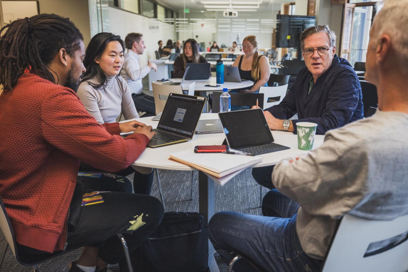 GSE Professor Mitchell Stevens (right, front facing) meets with students in a breakout session.