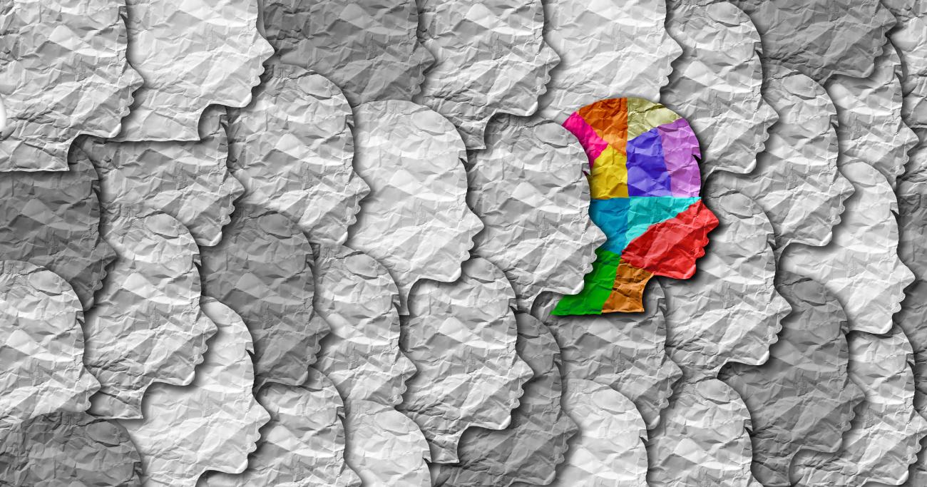 Illustration of a colorful head among black and white heads