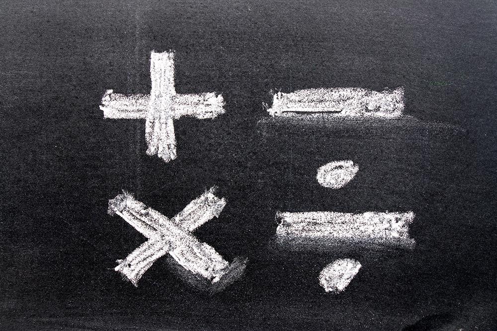 Mathematical operators written in chalk. 