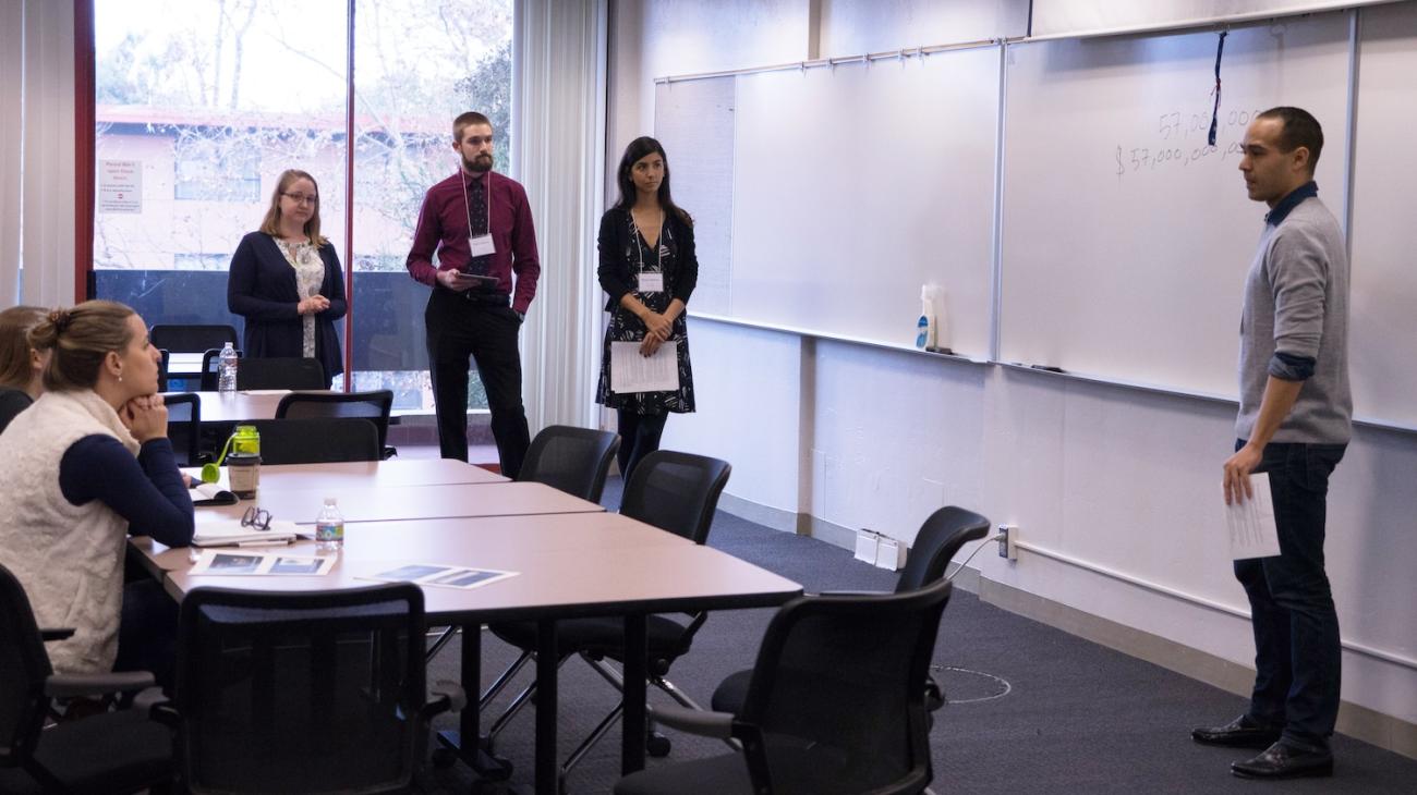 Master's students present their proposal to alumni panelists during the POLS Challenge. (Photo: Marc Franklin)