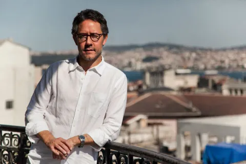 Batuhan Aydagül, MA ’02, in 2013 outside the Education Reform Initiative's office in the Karakoy neighborhood of Istanbul. (Phot